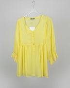 Blouse empire jaune Mam's Ailes sur cintre vue de face boutonnage central manches évasées