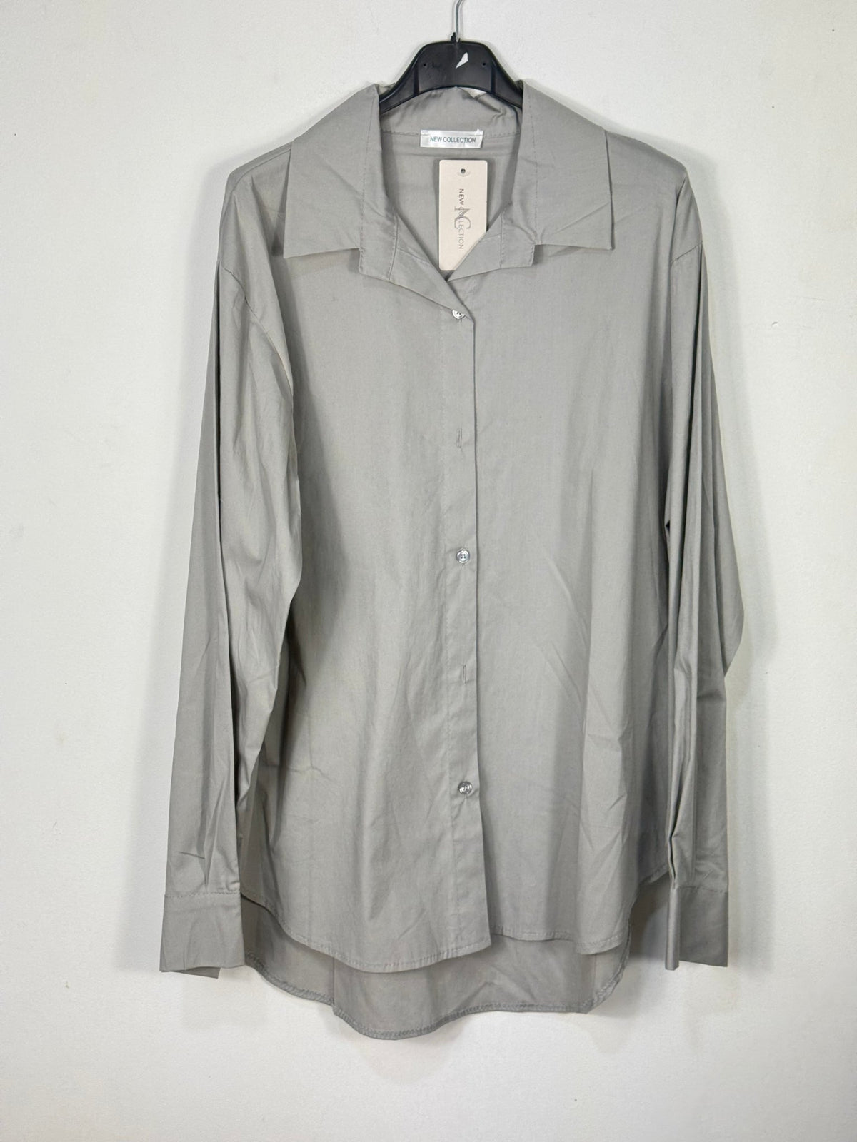 Chemise grise unie en coton photographiée de face sur cintre.