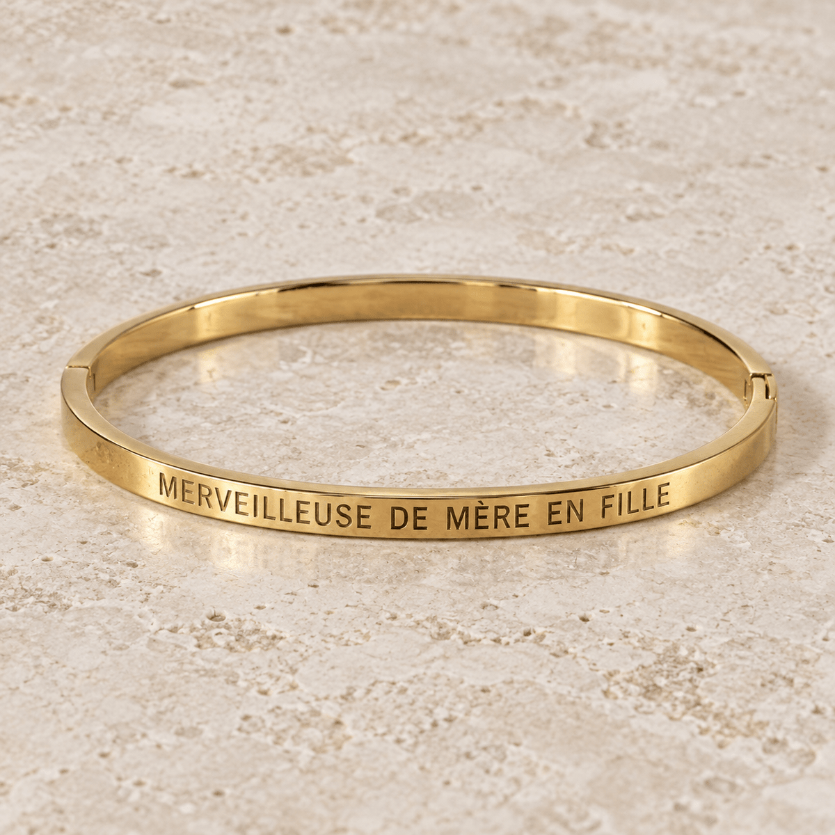 Jonc doré Merveilleuse de mère en fille sur pierre claire, photo retouchée de la gravure.