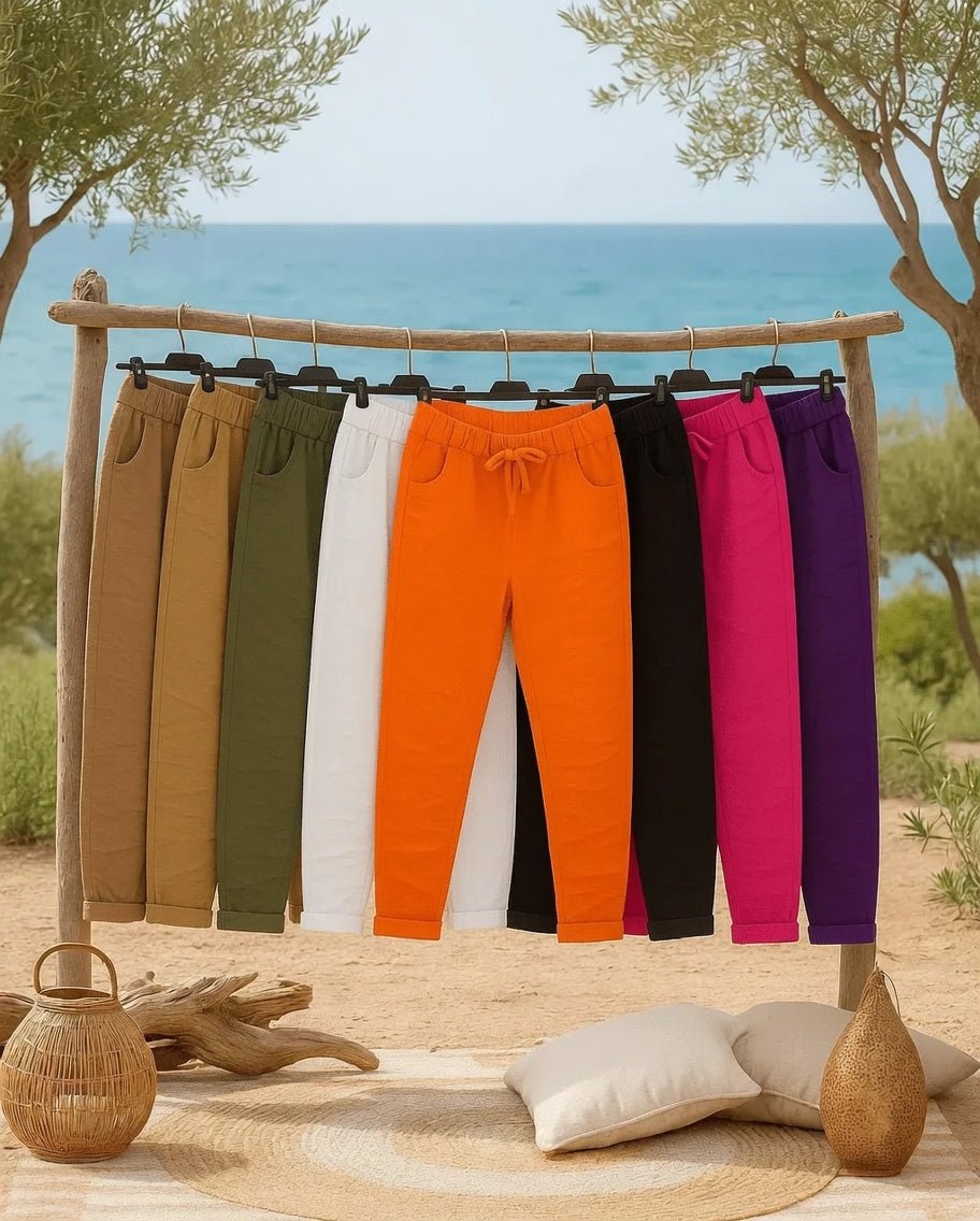 Collection de Pantalons Magiques femme en plusieurs coloris sur portant, ambiance bord de mer