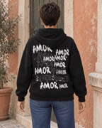 Dos du sweat AMOR noir avec inscriptions et éclaboussures blanches