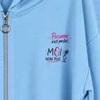 Détail retouché du message Personne n’est parfait… moi non plus, rose et noir, à côté du zip argenté à anneau