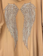 Détail ailes strass dos veste oversize – motif lumineux féminin
